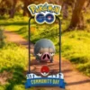 Promotional image for Pokémon GO Community Day with the logo and a phone frame showing a Pokémon on a sunny park path.