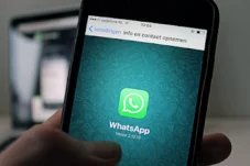 Close-up of a smartphone screen showing the WhatsApp app icon on the home screen.