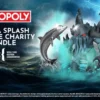Monopoly charity bundle ad with a dark ocean backdrop, a glowing sea monster, a shark-like figure, and a blue sea serpent rising from waves. Logos for Monopoly and charity shown.